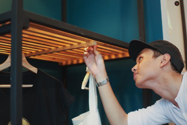 Wa'iz checking out a simple yet unconventional clothes rack he designed. Picture: Hj Safwan